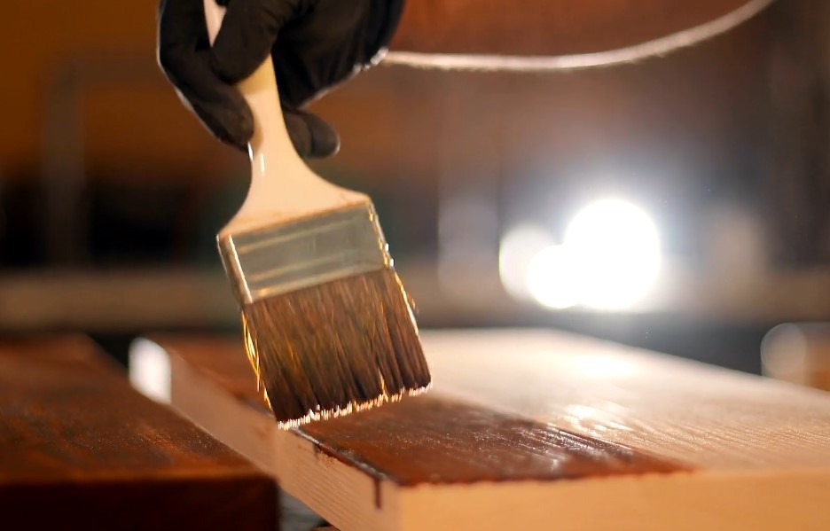 Close up photo of a wood painting with a brush