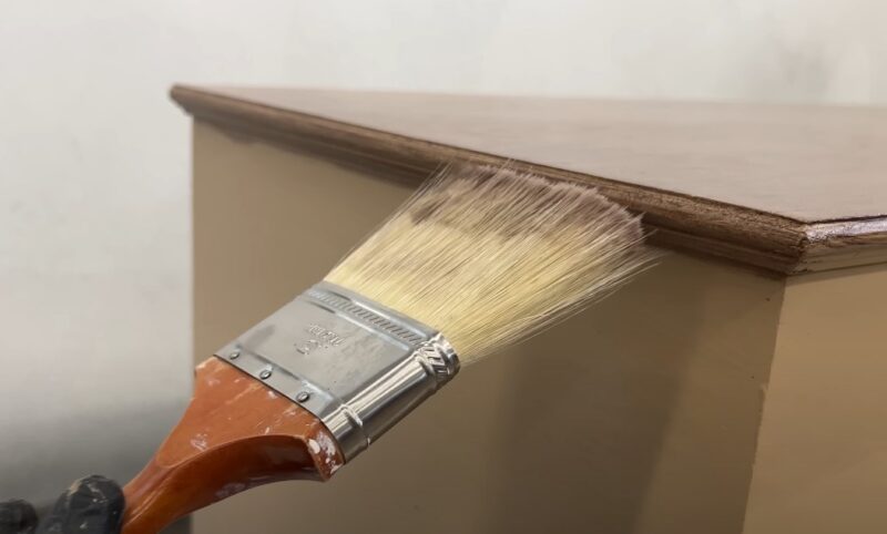 Close up photo of a brush painting wooden surface